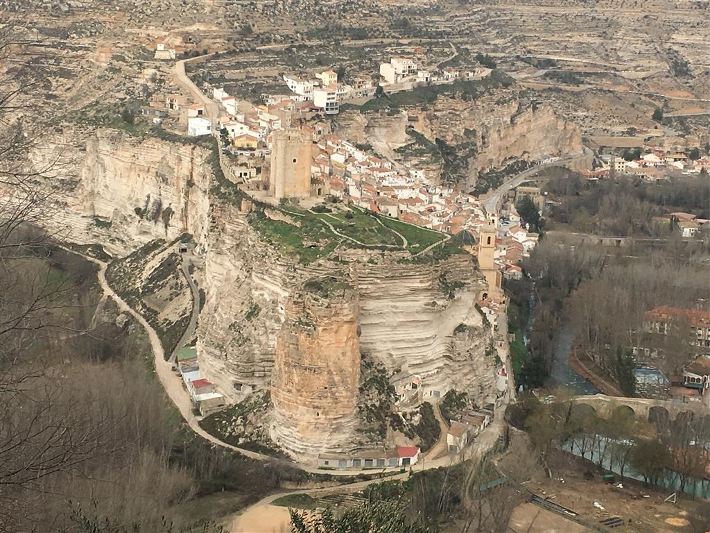 Meandro encajado de Alcalá del Júcar. Se observa la erosión diferencial de las diferentes capas rocosas de la Formación Alcalá del Júcar  y pequeños coluviales asociados a los escarpes, así como la torre principal del castillo almohade (siglos XII-XIII)